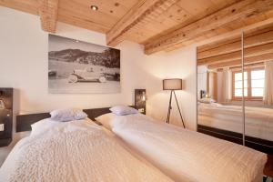 two beds in a bedroom with a car on the wall at Ferienhaus Steinbacher direkt am Tegernsee in Tegernsee