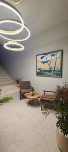 a lobby with benches and a table and a chandelier at Velar Hotel Boutique in Korçë
