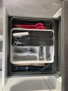 a drawer filled with utensils in a cabinet at Boarding Suite in Wendlingen am Neckar