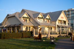 a building with metal roof in a park at Sidney Waterfront Inn & Suites in Sidney