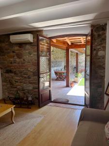 an open door in a living room with a stone wall at Mas Can Calet Aparthotel in Les Franqueses del Vallès