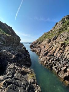 a body of water between two rocky cliffs at Hotel Restaurante el Fornon in Novellana