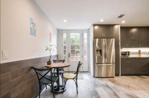 a kitchen with a table and chairs and a refrigerator at Private room shared full bathroom Torrey pines golf UCSD west in San Diego