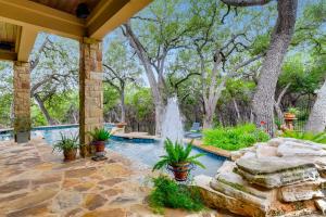 a swimming pool with a fountain in a yard at * Luxury 4500 sf home* Pool Spa * near Lake Austin in Austin