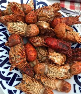 a pile of crabs on a plate on a table at Hotel Restaurante el Fornon in Novellana