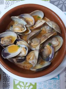 a bowl of oysters on a table at Hotel Restaurante el Fornon in Novellana
