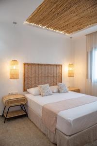 a bedroom with a large bed with two pillows at Anais Of Naxos in Agia Anna Naxos