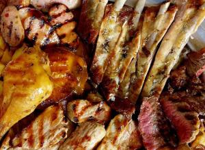 a close up of a plate of food with meat at Hotel Restaurante el Fornon in Novellana