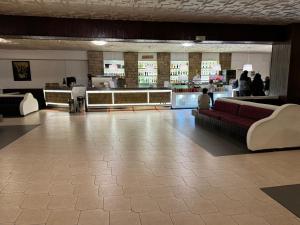 a lobby with couches and tables in a building at Alto Sangro House in Roccaraso