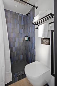 a bathroom with a toilet and a shower at Riverside Tower Hotel in New York