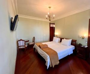 Giường trong phòng chung tại Aroso Paço Hotel