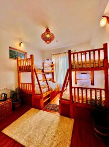 a bedroom with three bunk beds and a chandelier at Unwind Stays in Nagar