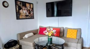 a living room with a couch with a glass table at Private Bedrooms Geneva in Geneva