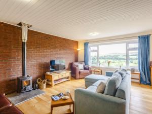 a living room with a couch and a fireplace at 3 bed in Rothbury 63025 in Rothbury