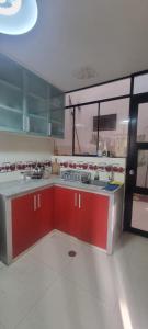 een grote keuken met rode kasten in een kamer bij Casa / Departamento en Chiclayo in Chiclayo