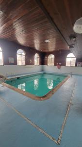 a large swimming pool in a large room with at Days Inn by Wyndham Sheridan in Sheridan