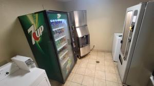 a soda machine in a kitchen next to a refrigerator at Days Inn by Wyndham Sheridan in Sheridan