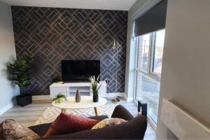 a living room with a couch and a table at Inviting 1-Bed Apartment in the heart of Sheffield in Sheffield