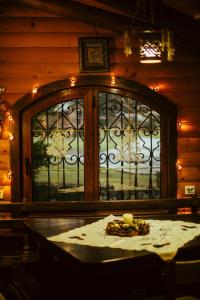 a room with a table and a window with lights at Хутір Стаєчне in Bagna