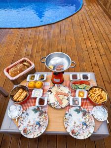 a picnic table with plates of food and a pot of food at Joy Sapanca in Sapanca