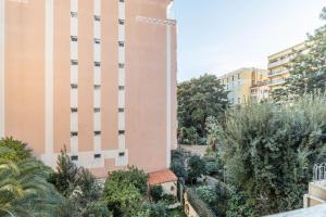 an apartment building with a garden in front of it at Menton Casino in Menton