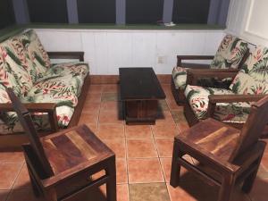 uma sala de estar com três cadeiras e uma mesa em The Hawaii Red House Apartment Private em Keaau