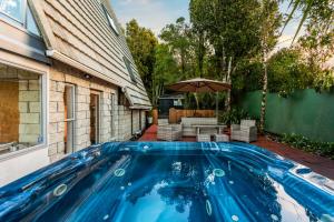 a swimming pool in the backyard of a house at Nature's Nook with Spa, Deck and Views in Piha