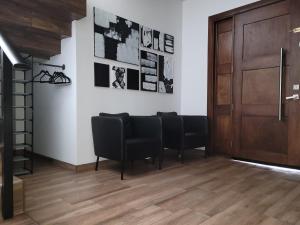 una sala de espera con sillas negras y una puerta de madera en Spacious Tijuana Beach Home With Private Heated* Pool en Tijuana