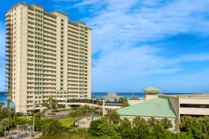a large white building with the ocean in the background at Celadon Beach in Panama City Beach