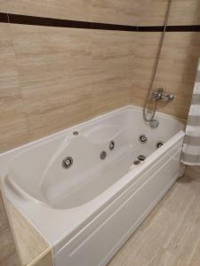 a large white bath tub in a bathroom at Azores Essence - Paim in Ponta Delgada