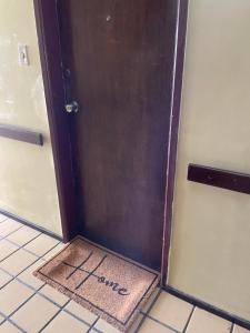 a brown door with the word home written on it at Flat com Ar Condicionado Ana Regis AP 307, Salvador in Salvador