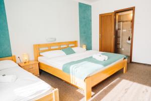 a bedroom with two beds with towels on them at KAPINA sk - Dom Jasna in Liptovský Mikuláš