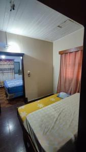 a bedroom with a bed and a mirror in it at Alojamiento Eldorado in Eldorado