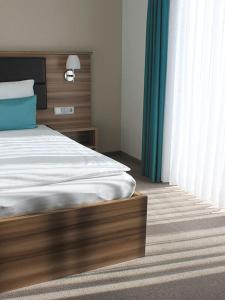 Un pat sau paturi într-o cameră la Gästehaus am Reisberg