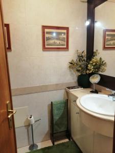 a bathroom with a sink and a mirror at Cascais Luxury Top Floor Apt in Cascais