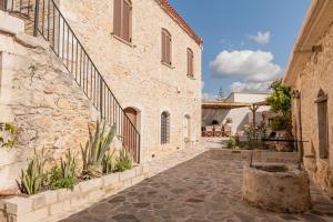 an alleyway in an old building with a stone wall at Antama Living, Luxe Stonehouse with Pool & BBQ in Rethymno Town