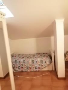 a small room with a bed in the attic at Cascais Luxury Top Floor Apt in Cascais