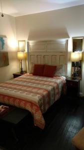 a bedroom with a bed with red pillows and two lamps at Sunset Studio with Full Kitchen and no fee in Florence