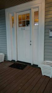 a white front door of a house with a porch at Sunset Studio with Full Kitchen and no fee in Florence
