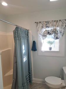 a bathroom with a shower curtain and a toilet at Sunset Studio with Full Kitchen and no fee in Florence
