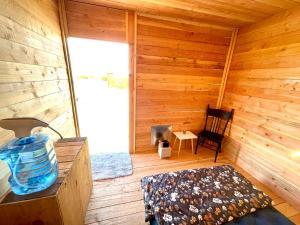a room with a wooden cabin with a chair at Beysicair Tents & Campground in California City