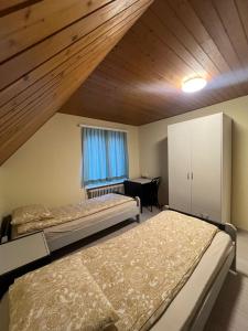 a bedroom with two beds and a desk in it at Niederdorf, Baselland Hotel in Niederdorf