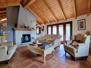 a living room with couches and a fireplace at Casa Del Ingles - Luxury Private Village & Pool in Rural Valley in Pontevedra