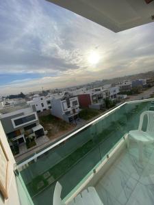 a balcony with a swimming pool with a view of a city at Appartement neuf et élégant in Fès