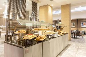 a buffet line with a lot of food on display at Le Méridien Santiago by Marriott in Santiago