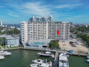 a large building with boats in a marina with a red balloon at Vista Mar: Bay Views Close to Miami Attractions in Miami Beach
