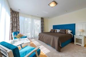 a bedroom with a bed and a table and chairs at Villa K Dubrovnik-5 bedroom villa with sea access in Zaton +34 photos