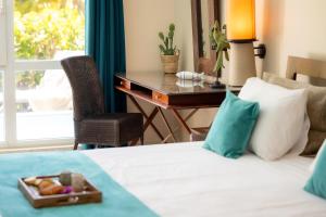 Voodi või voodid majutusasutuse Physacap Suites & Villas toas