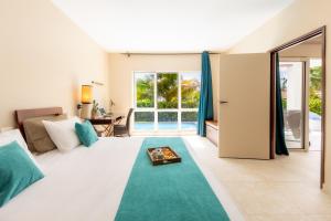 Voodi või voodid majutusasutuse Physacap Suites & Villas toas