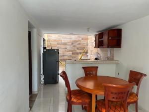 a kitchen with a table and chairs and a refrigerator at Casa - chalet Cartagena in Cartagena de Indias